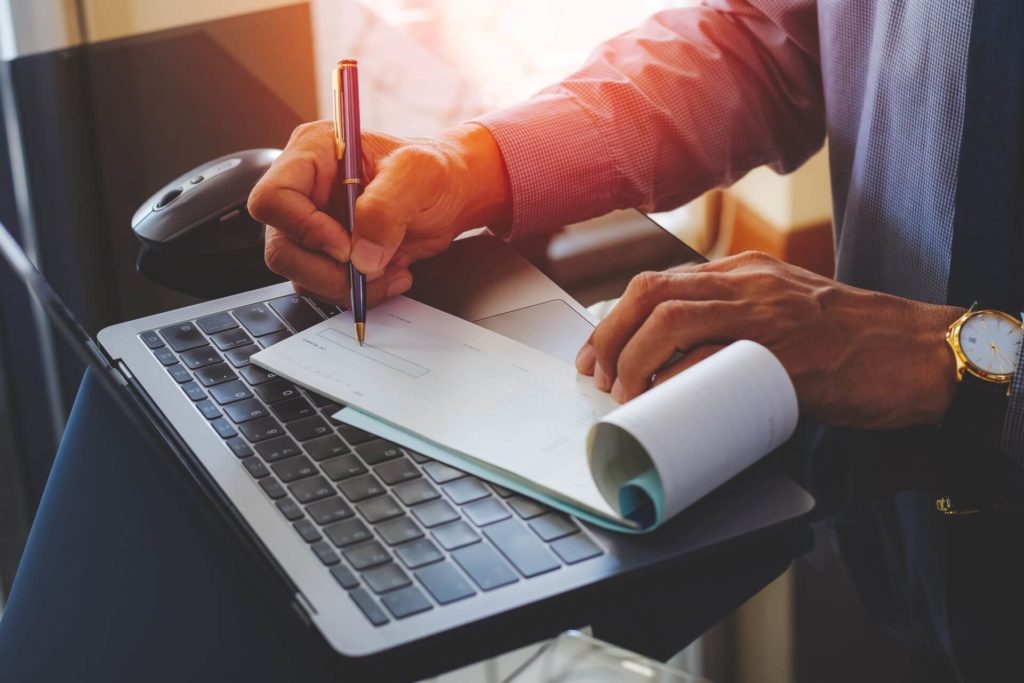 man writing a check