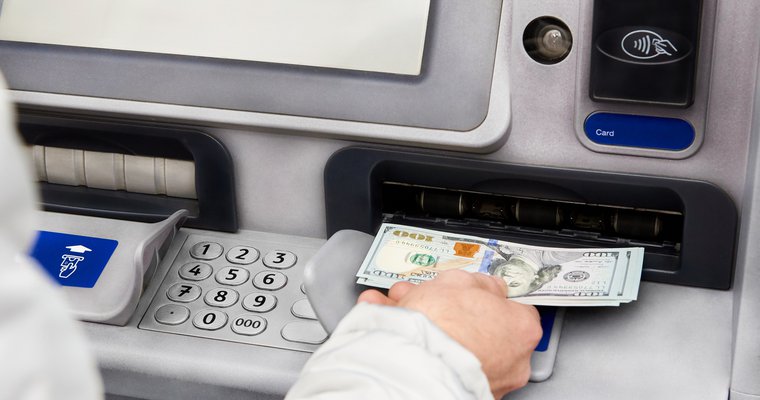 man withdrawing money when his account is overdrawn