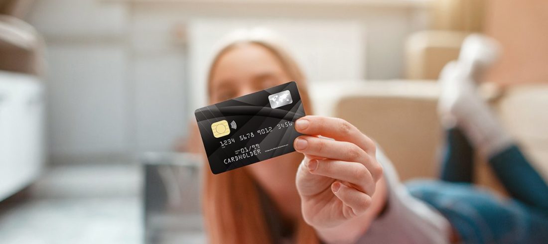teenager holding debit card