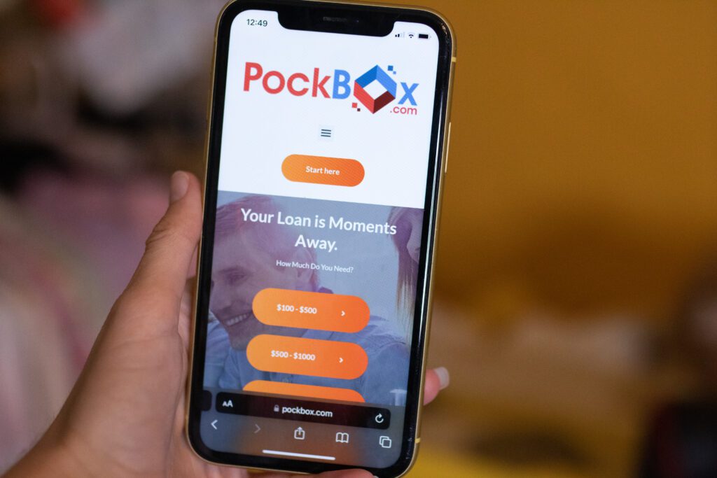 Hand holding phone with PockBox app