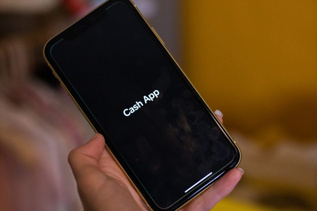 hand holding phone with cash app logo