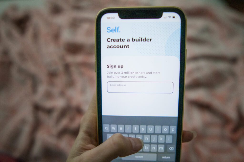 person creating self credit builder account on phone screen