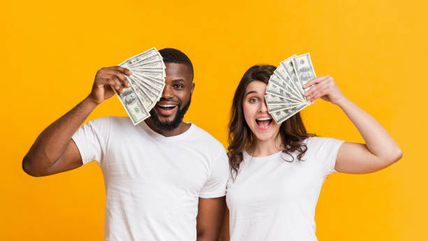 Man and woman holding $1,000 cash