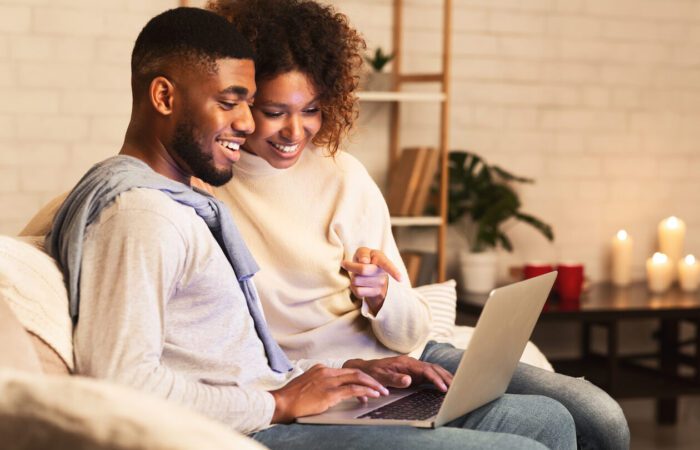 happy couple using laptop (1)
