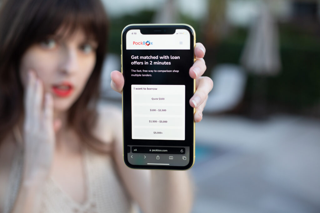 Woman holding a phone that displays PockBox instant loan choices